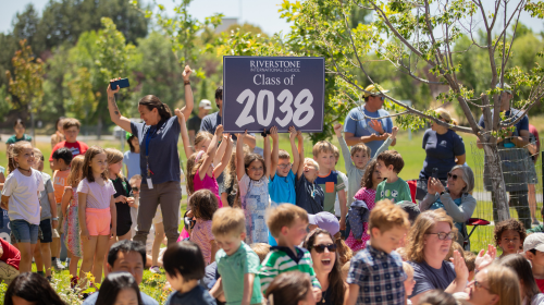 kids holding class of 2038 sign